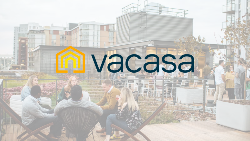 Rooftop terrace with people socializing and a prominent Vacasa logo overlay.