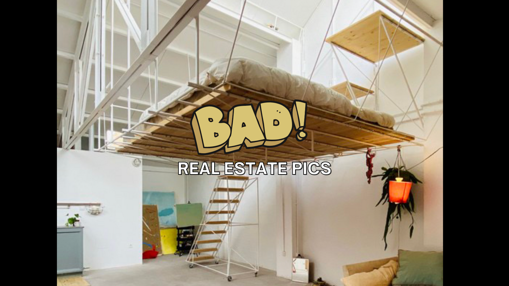 Loft interior with a suspended platform bed and metal stairs, overlaid with comic-style text 'BAD! REAL ESTATE PICS'.