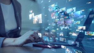 A person typing at a desk with floating, interconnected thumbnail images representing digital media and networks behind them.
