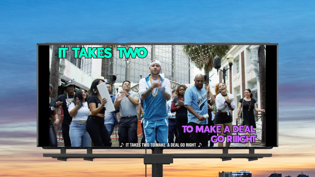Diverse group dancing on a city street; bold teal text 'IT TAKES TWO' and purple 'TO MAKE A DEAL GO RIGHT' on a large billboard.