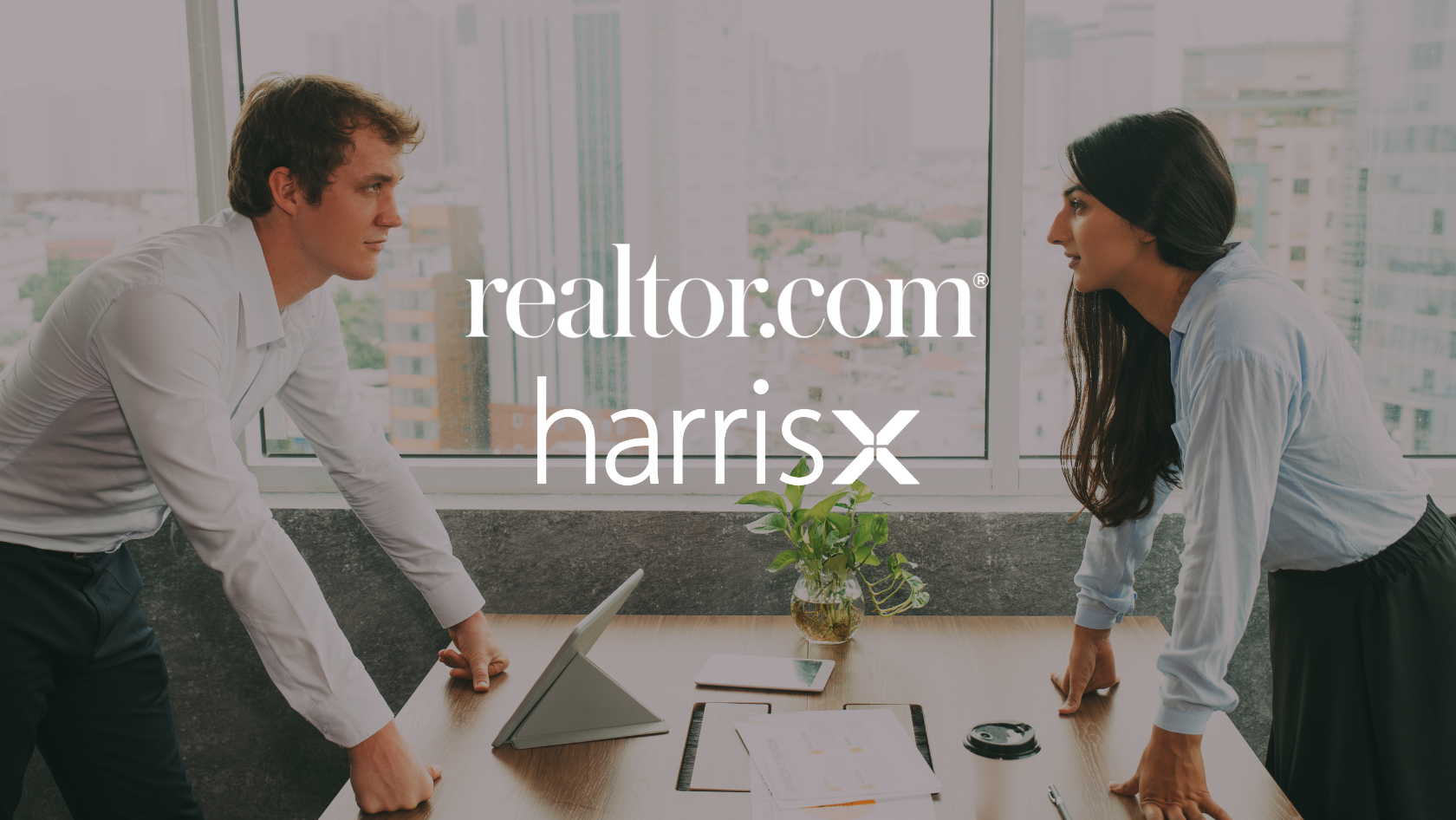 Two colleagues lean on a conference table in a bright city-office, with realtor.com and HarrisX logos overlaid on the image.
