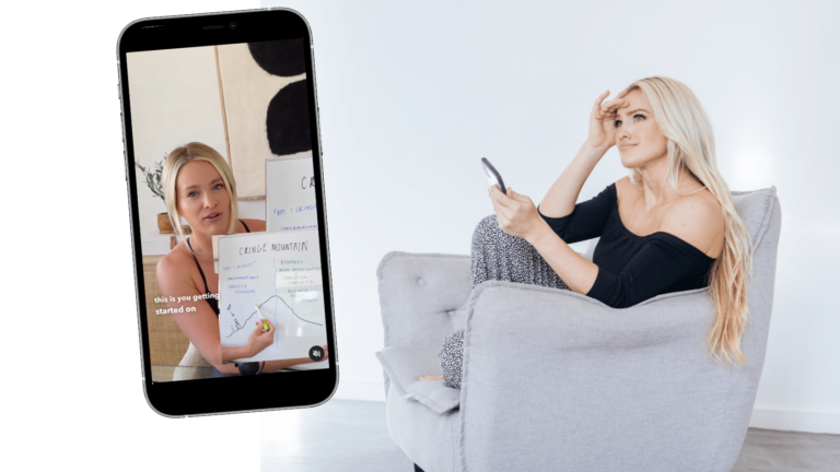 A woman explains a whiteboard diagram during a video call shown on a tilted smartphone, with a second woman relaxing on a gray chair in the background in a bright room.