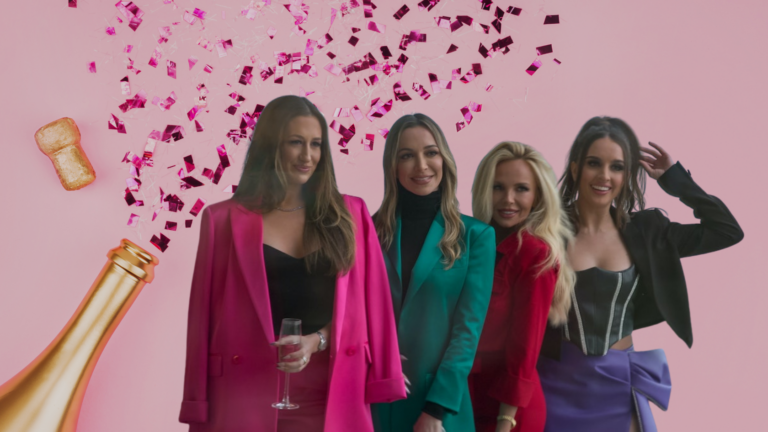 Four stylish women posing together at a party with pink background, champagne bottle and confetti above them.