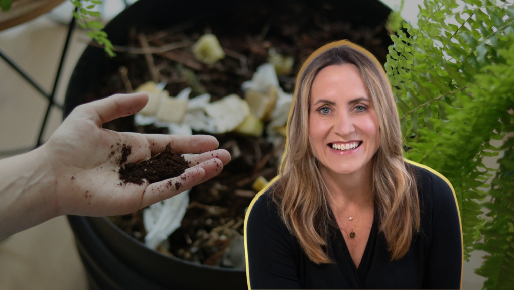 Hand holding dark compost soil in foreground; smiling woman and a compost bin with green plants in the background.