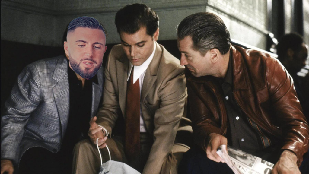 Three men in vintage suits sit together, one holding a newspaper and looking at it with the others nearby, as if discussing something.
