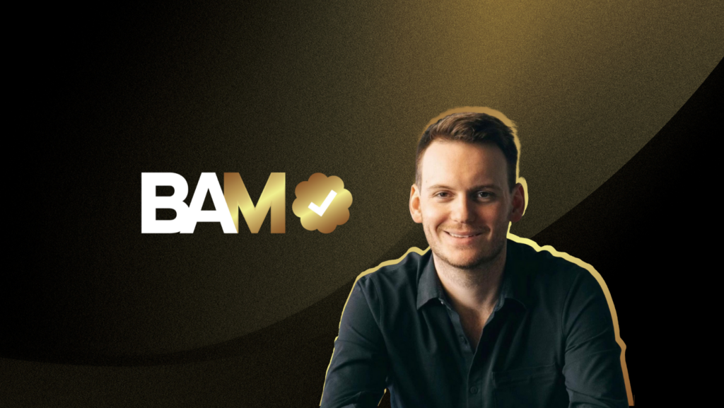 Smiling man in a dark shirt with a gold-edged outline sits beside the BAM logo featuring a gold M and checkmark badge on a black-gold gradient background.