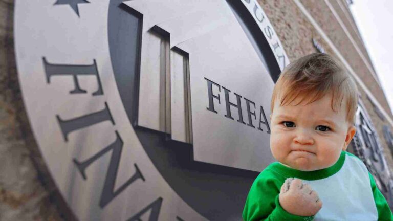 Young child in a green and white shirt stands close to a large circular sign that says “THEATRE,” fist clenched with chalk on his hand.
