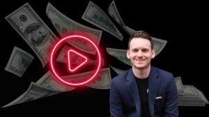 Smiling man in a navy blazer sits against a black background with a glowing red play button and flying dollar bills around him.
