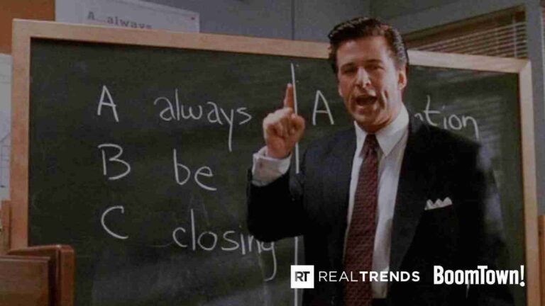 Man in a suit pointing at a chalkboard with handwritten words, including 'A', 'B', and 'C' phrases, in a classroom or office setting.