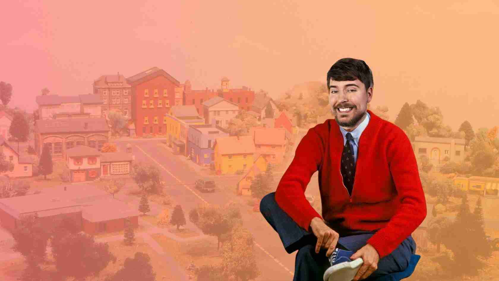 Smiling man in a red cardigan sits in front of a pastel orange-pink cityscape background.