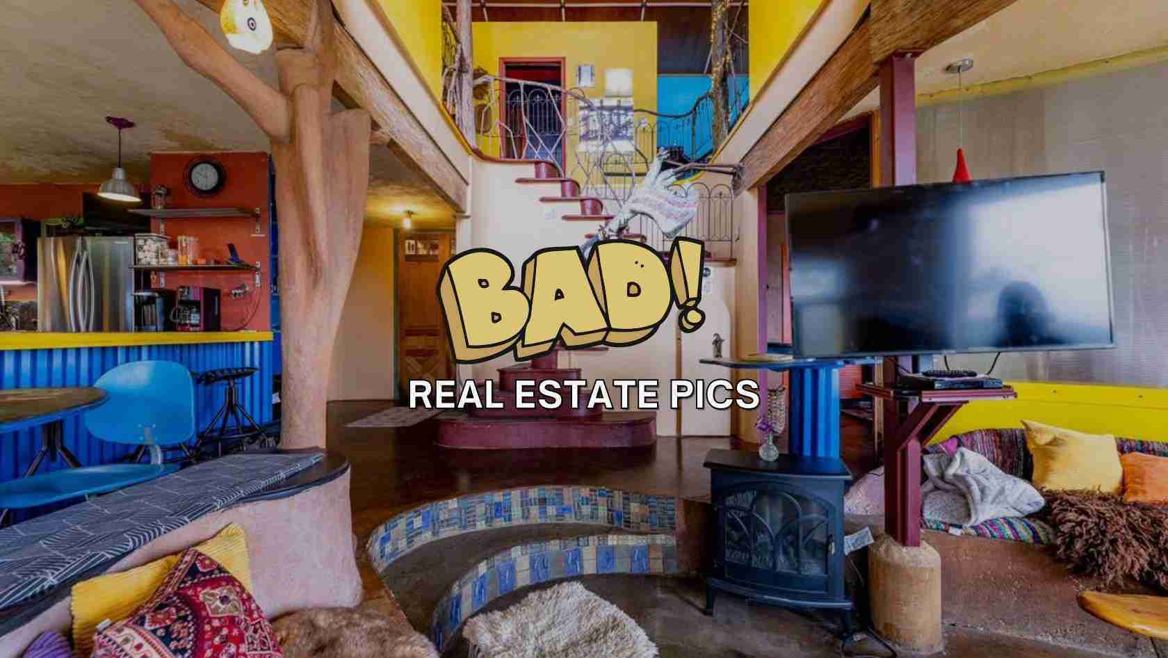 Bright, eclectic living space with blue seating, yellow walls, a fireplace, stairs, and a large TV, overlaid with a bold 'BAD!' cartoon and 'REAL ESTATE PICS' text.