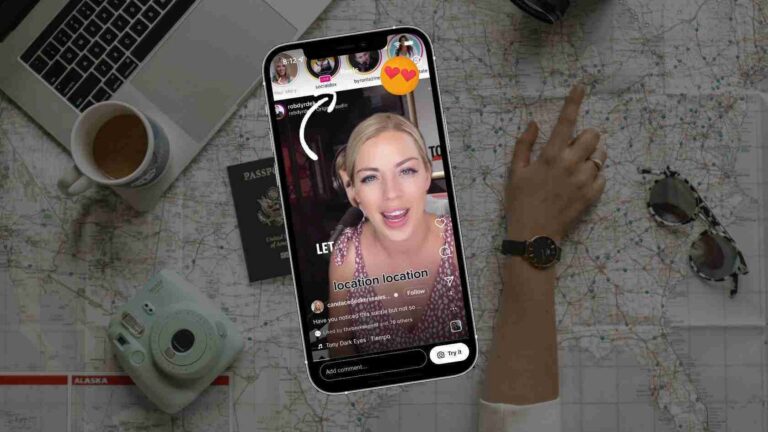 Smartphone livestreaming a woman against a map backdrop, surrounded by travel gear like a passport, camera, coffee mug, and laptop nearby.