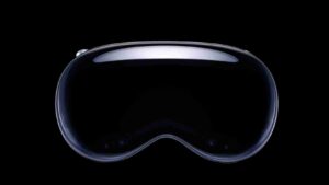 Front view of a glossy black VR headset lens against a black background, with a curved, reflective rim.