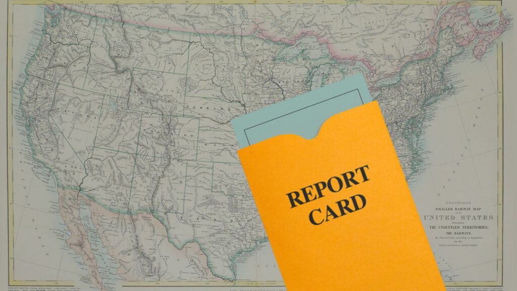 Vintage map of the United States with an orange report card folder laid over it, suggesting a geographic report or assessment tool used for evaluation.
