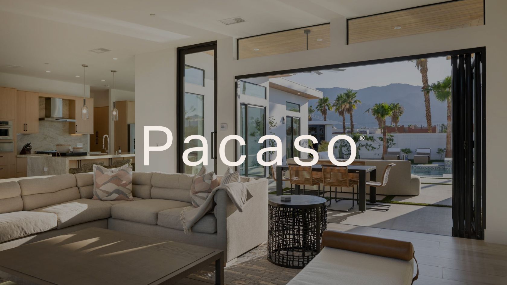 Open living area with beige sectional, kitchen, and sliding doors to an outdoor patio with a pool; Palacso watermark across the image.