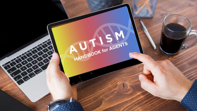 Tablet held by hands shows a gradient screen reading 'AUTISM HANDBOOK for AGENTS' on a wooden desk with a laptop and a coffee cup nearby