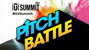 IO Summit 2023 Pitch Battle banner with bright blue and yellow lettering and a multicolor paint-splashed background