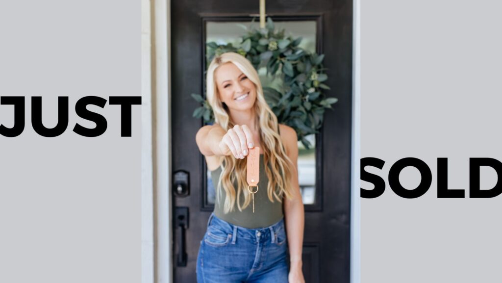 Real estate agent at a doorway, proudly holding up a house key with a 'JUST SOLD' backdrop.