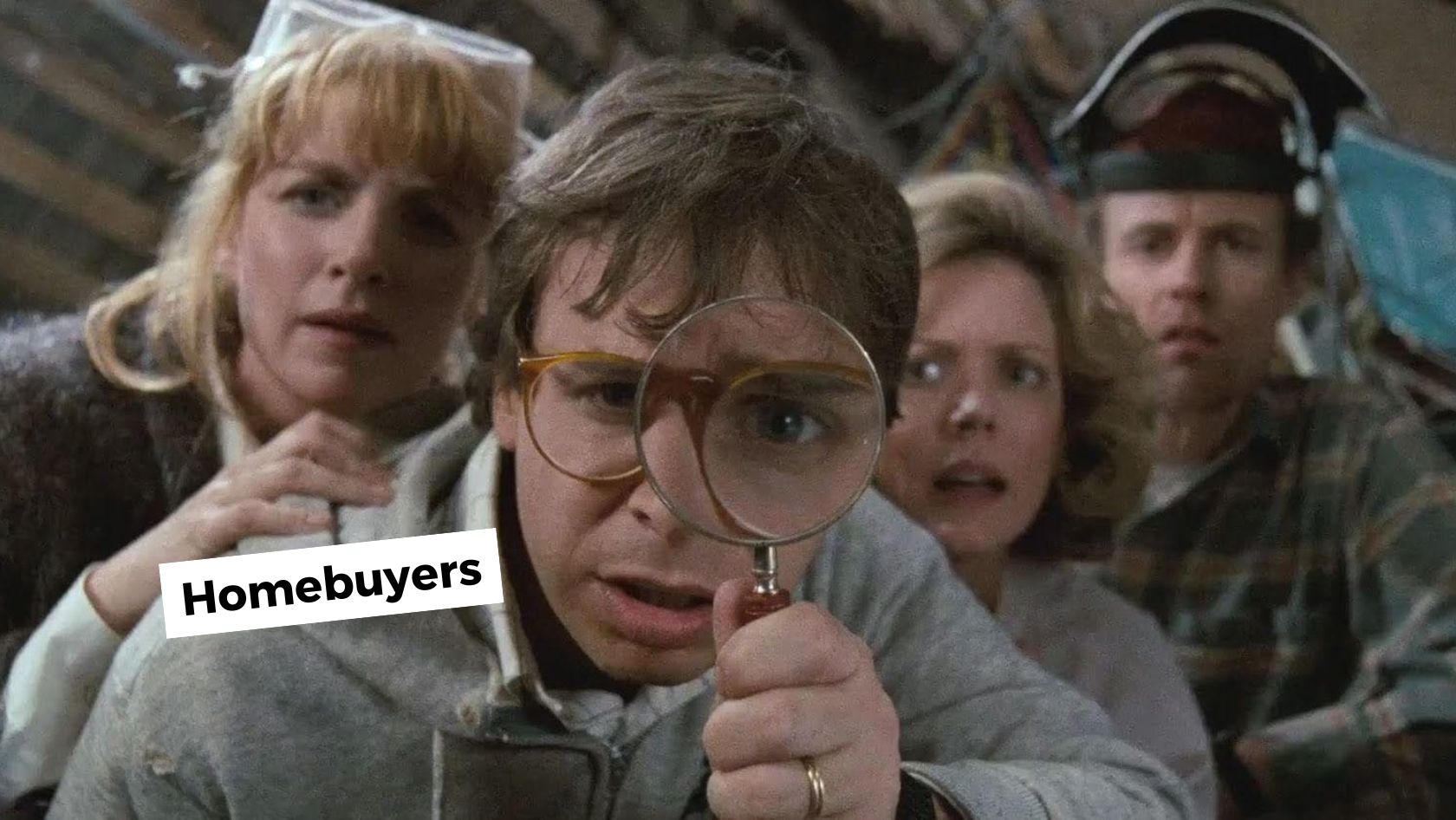 A group of four people peers through a magnifying glass, suggesting they’re investigating or inspecting closely for homebuyers.