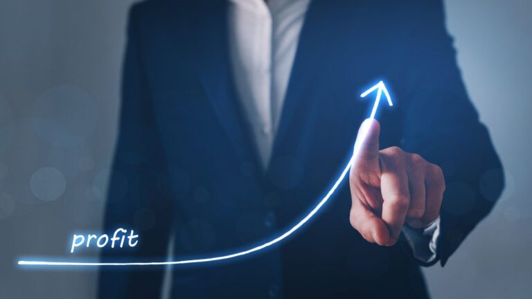 Businessperson in a suit drawing a glowing upward arrow labeled 'profit' to indicate growth and optimization of profits.