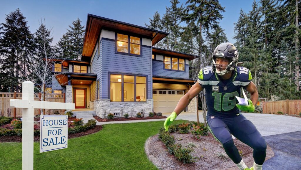 Blue modern two-story house with a 'House for Sale' sign in the front yard; a football player in Seahawks gear appears in the foreground.