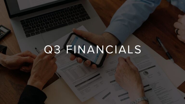 Meeting scene with hands reviewing financial documents and a smartphone on a wooden table, overlaid with 'Q3 FINANCIALS' text.