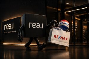 Black cube mascot walking with a RE/MAX shopping bag and balloon outside a Real Brokerage storefront.