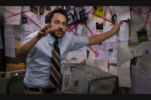 53% of Buyers Don't Understand the Home Buying Process. Here's Your Opening. - BAM Man in a light blue shirt and striped tie gesticulates aggressively while holding a cigarette, in a cluttered room covered with papers and red string connections behind him.
